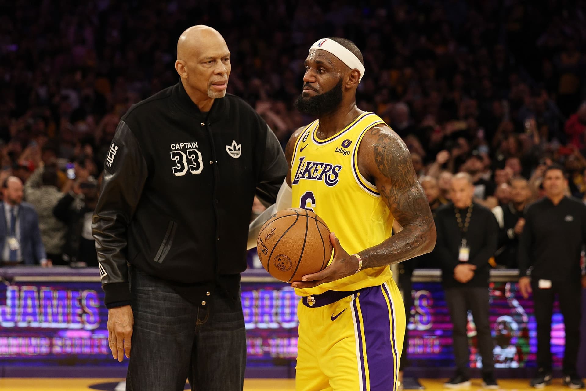 Kareem Abdul-Jabbar stands on court with LeBron James