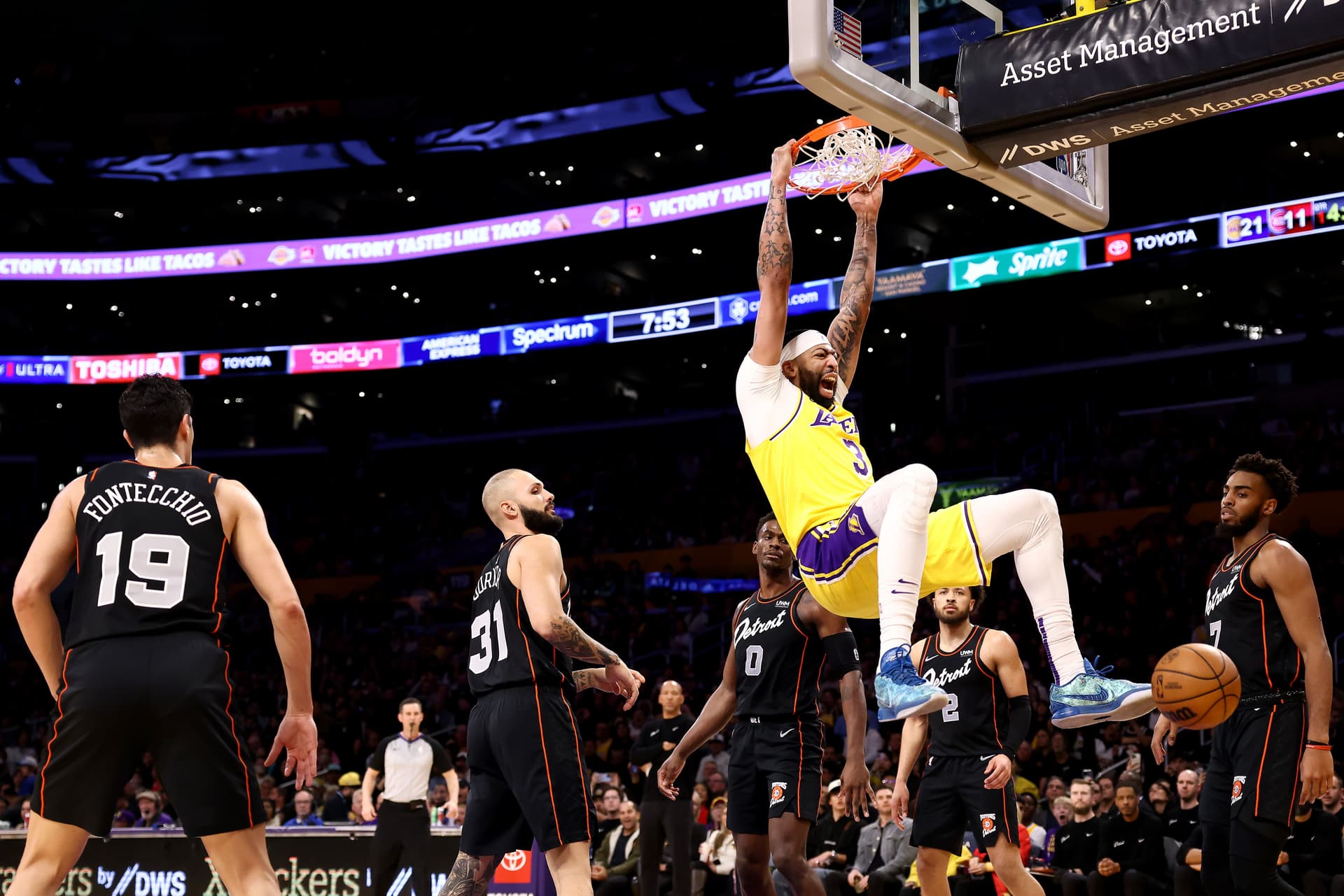 Anthony Davis #3 of the Los Angeles Lakers dunks the ball against Simone Fontecchio #19, Evan Fournier #31, Jalen Duren #0, Cade Cunningham #2 and Troy Brown Jr. #7