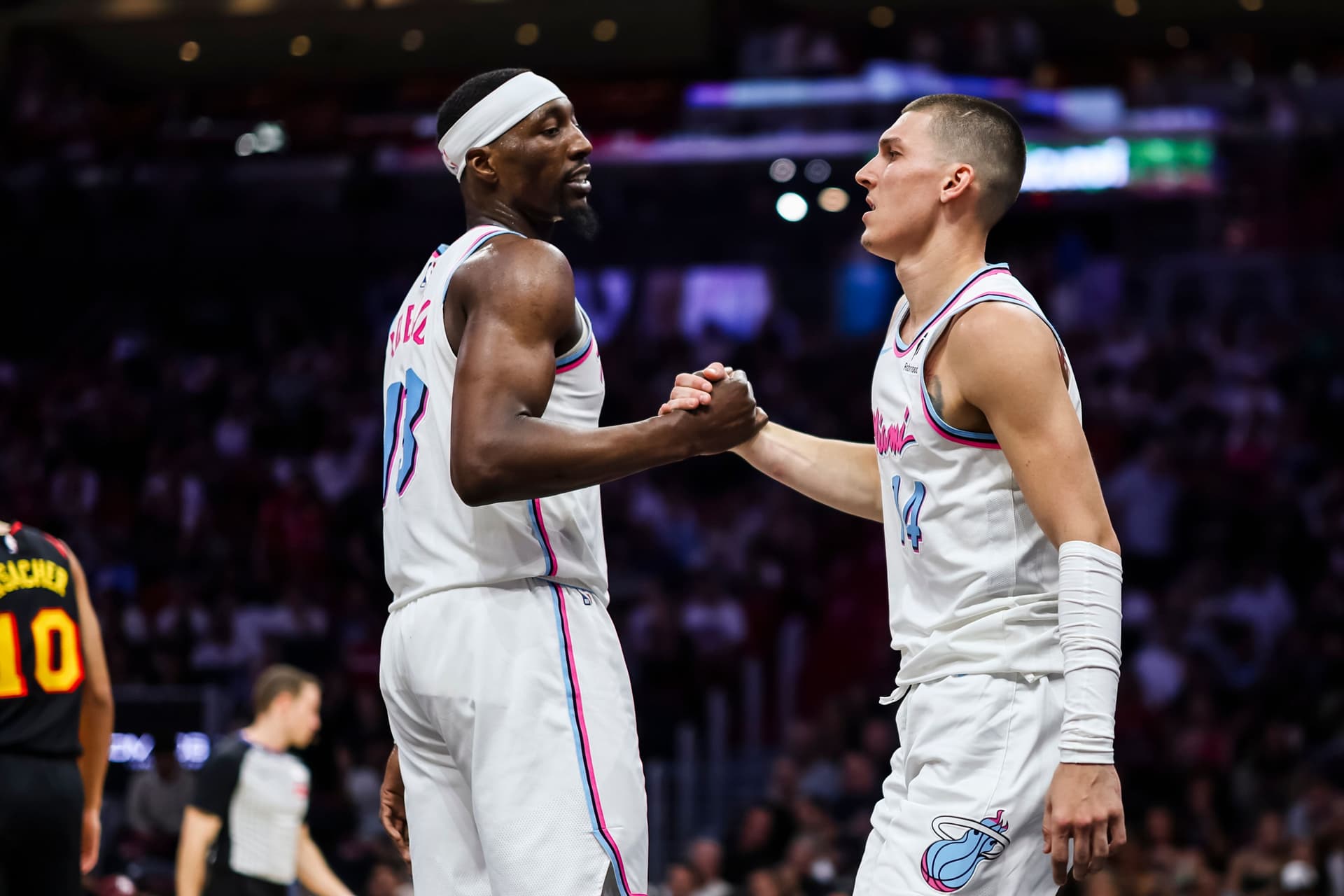 Bam Adebayo (L) #13 of the Miami Heat and Tyler Herro #14 of the Miami Heat reacts