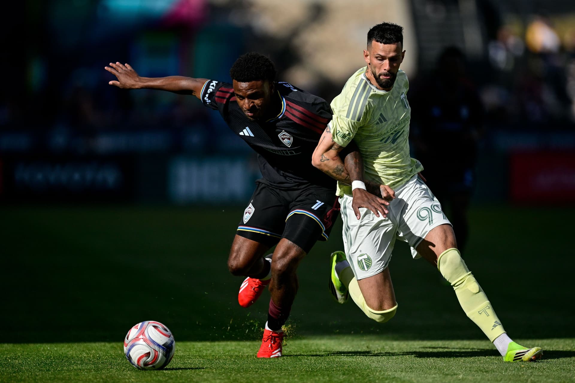 Dante Sealy works to control the ball against Kristoffer Velde