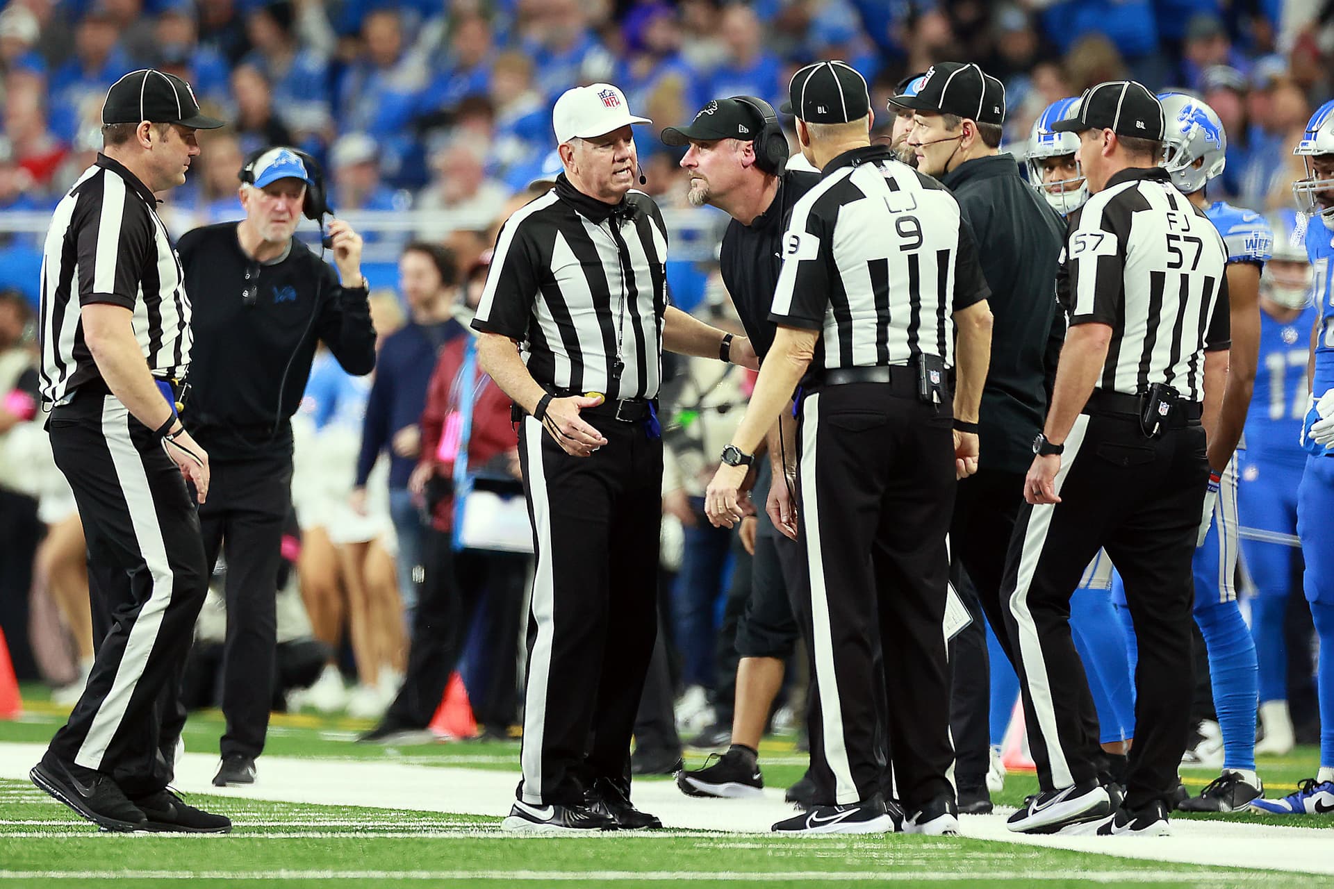 Detroit Lions head coach Dan Campbell talks with officials