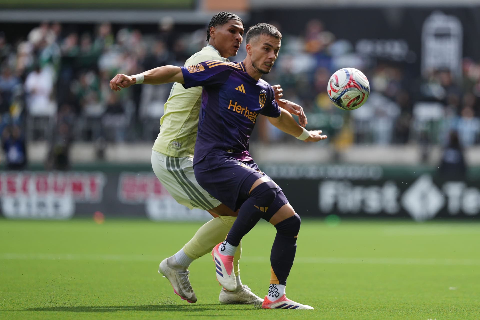 Erik Thommy #27 of Los Angeles Galaxy is challenged by Antony #11 of Portland Timbers