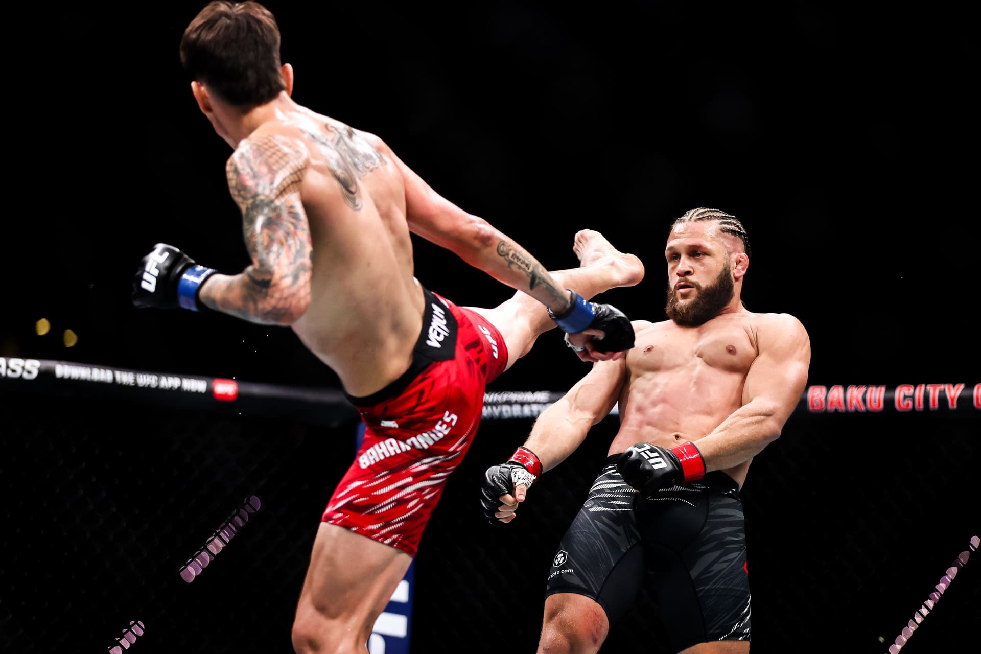 Ignacio Bahamondes of Chile punches Rafael Fiziev of Kazakstan