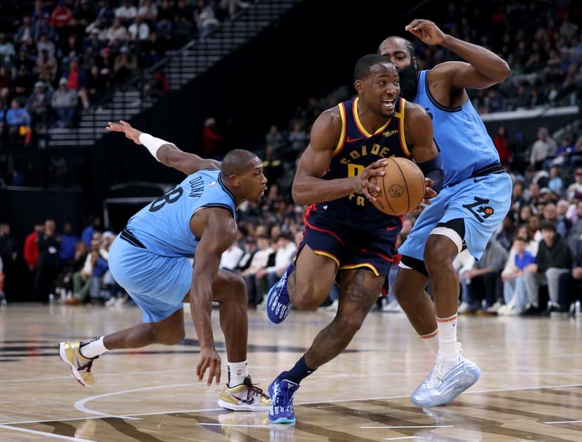 Jonathan Kuminga drives to the basket between Kris Dunn and James Harden