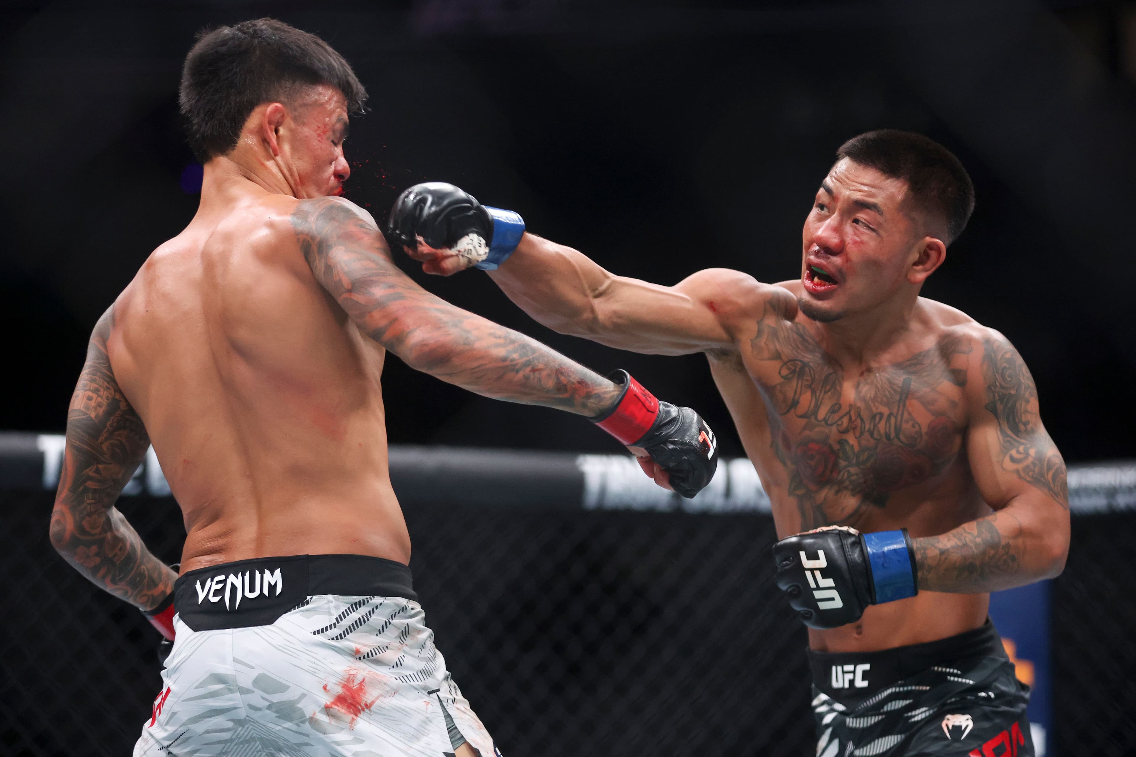 Joshua Van of Myanmar punches Brandon Royval of the United States