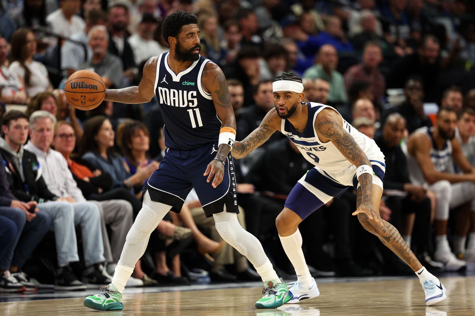 Kyrie Irving dribbles the ball against Nickeil Alexander-Walker