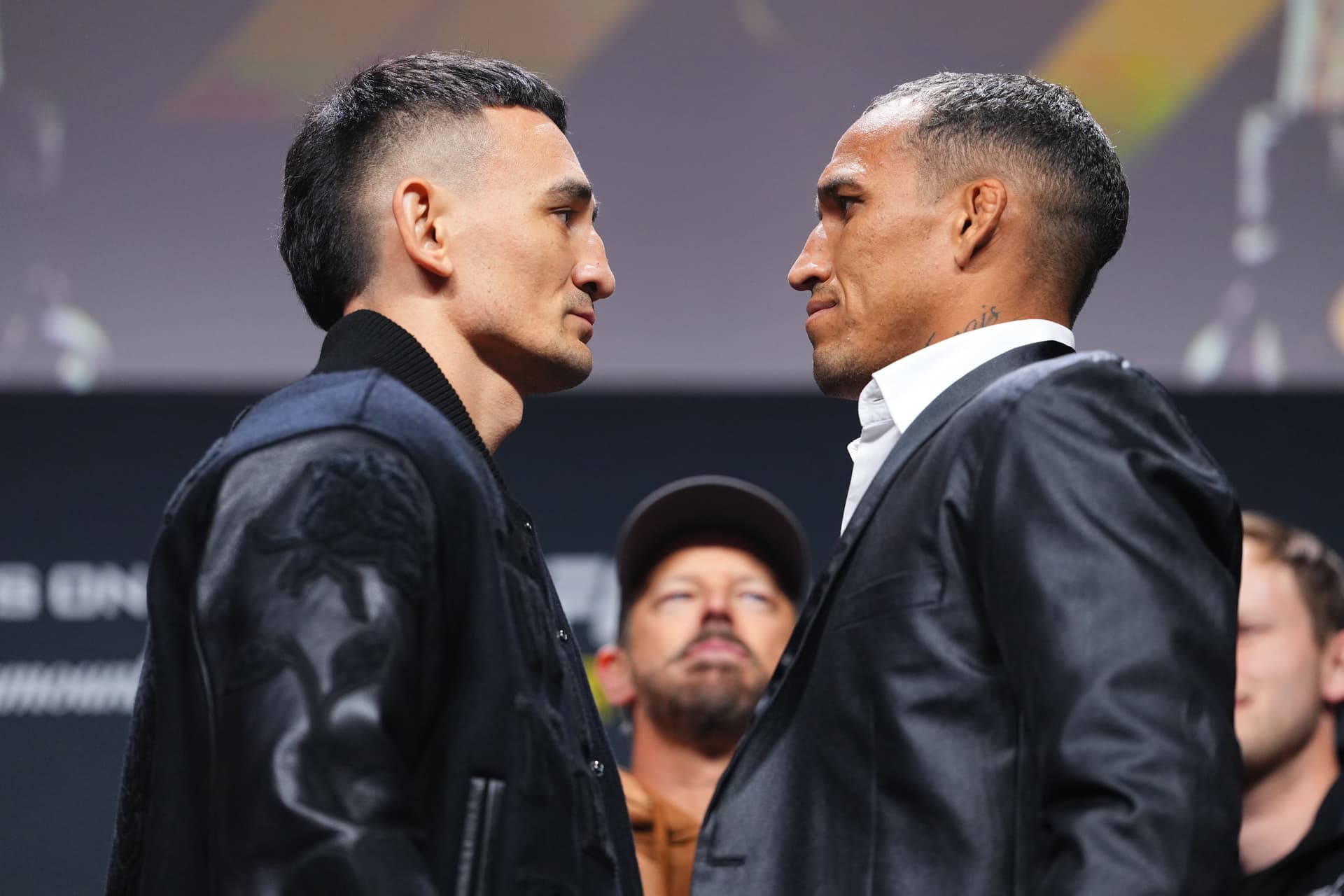 (L-R) Opponents Max Holloway and Charles Oliveira face off during the UFC