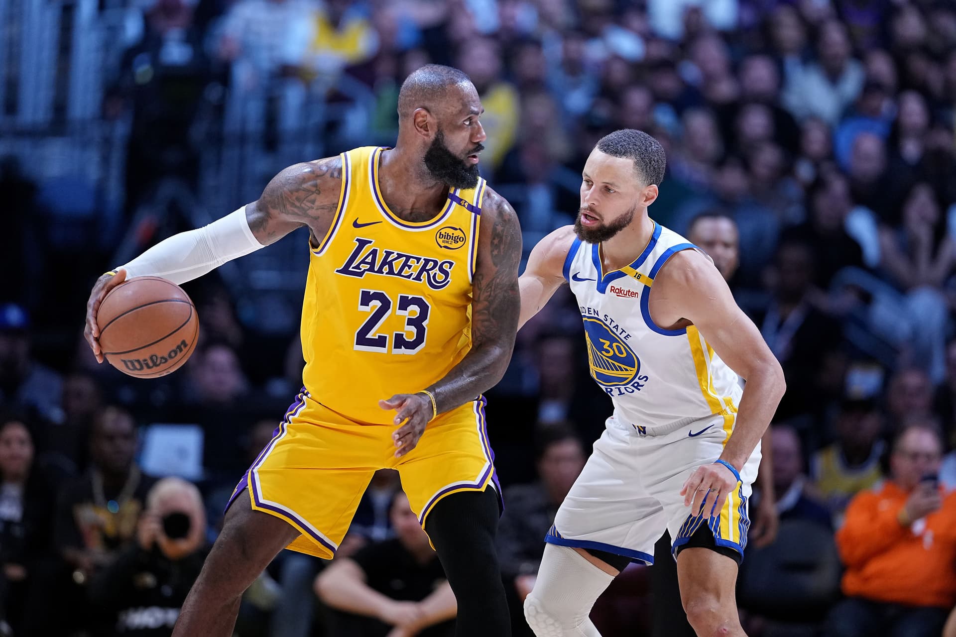 LeBron James #23 of the Los Angeles Lakers controls the ball against Stephen Curry