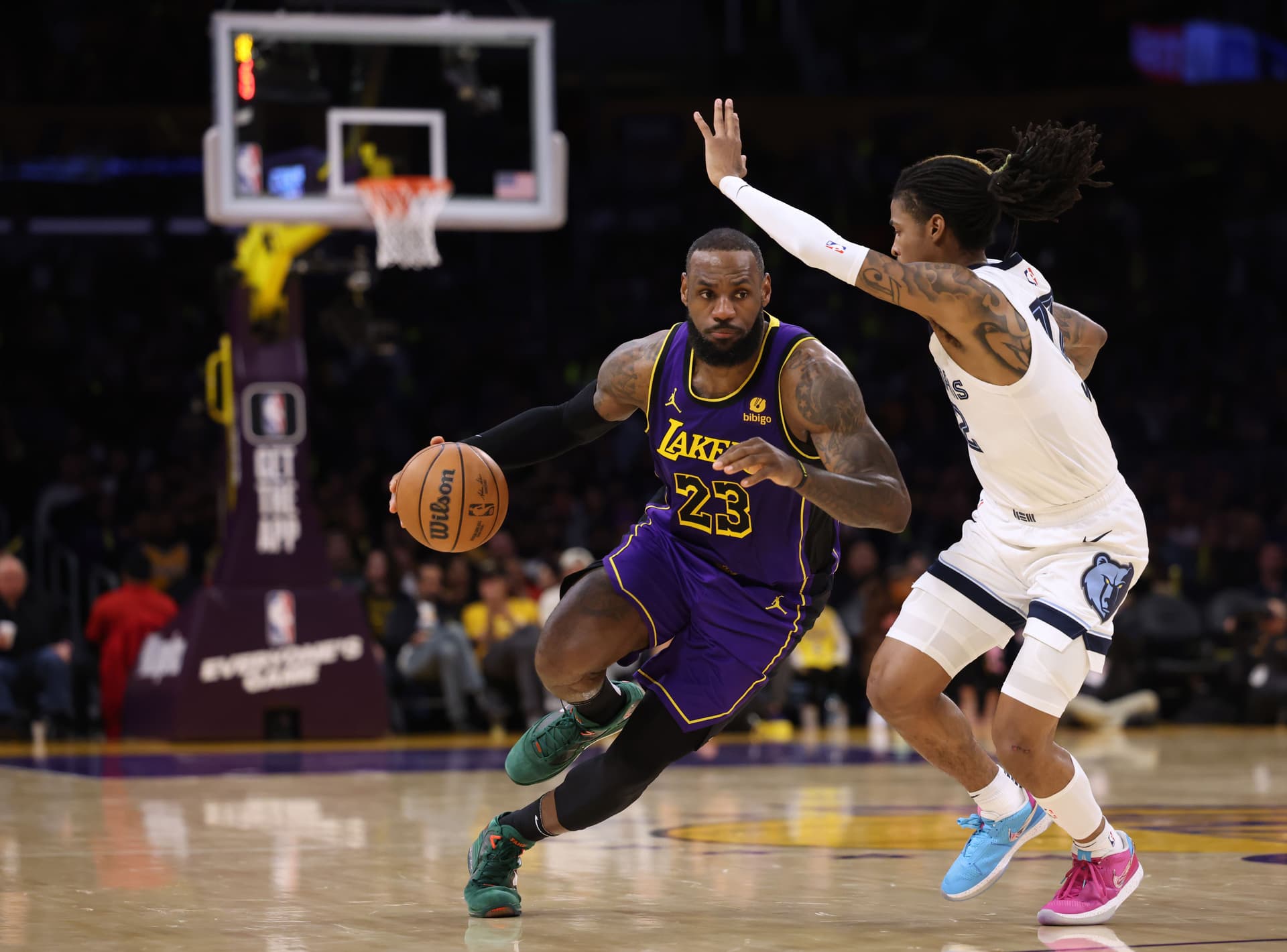 LeBron James #23 of the Los Angeles Lakers drives to the basket on Ja Morant #12