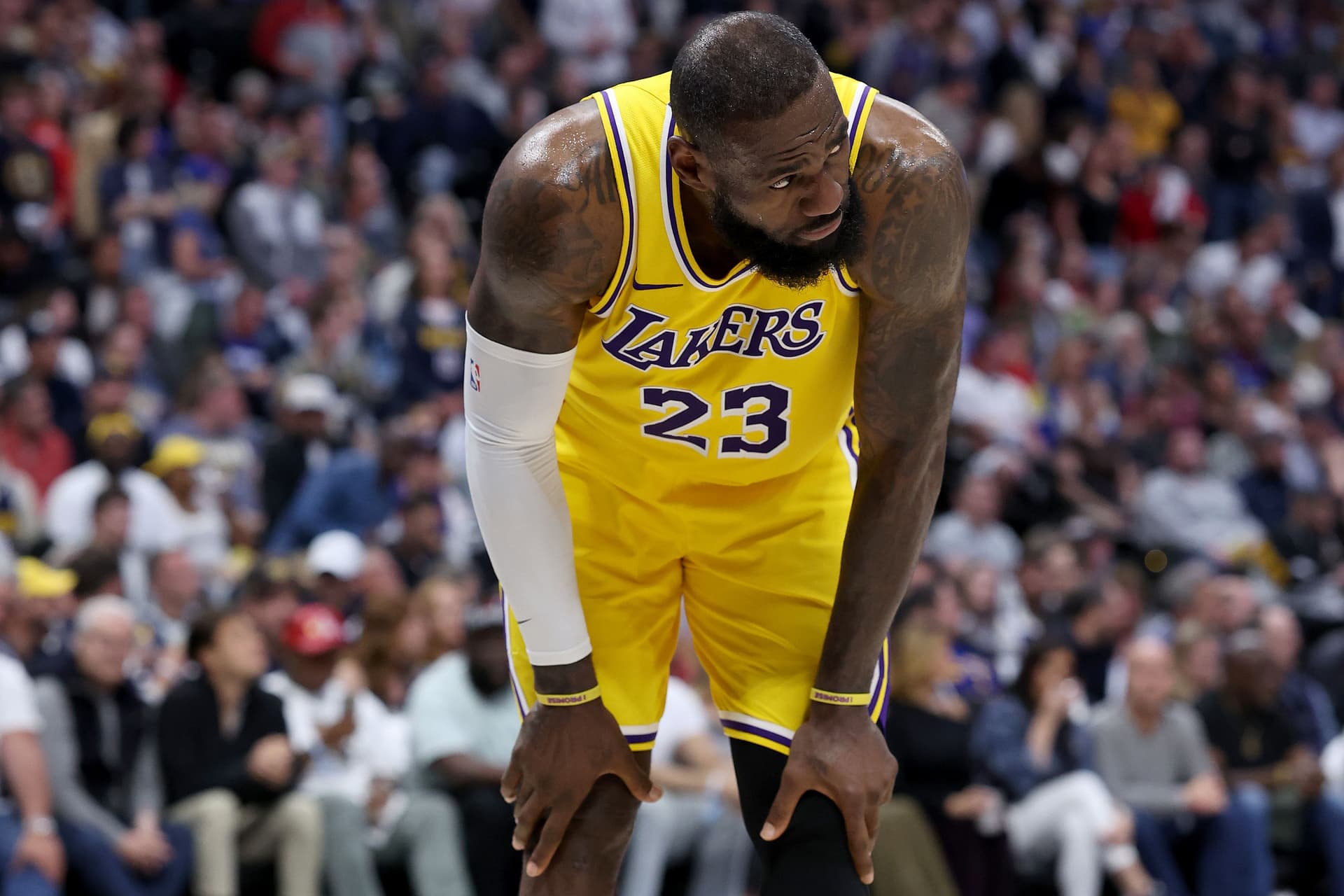 LeBron James #23 of the Los Angeles Lakers gathers himself after taking a hard hit while playing the Denver Nuggets