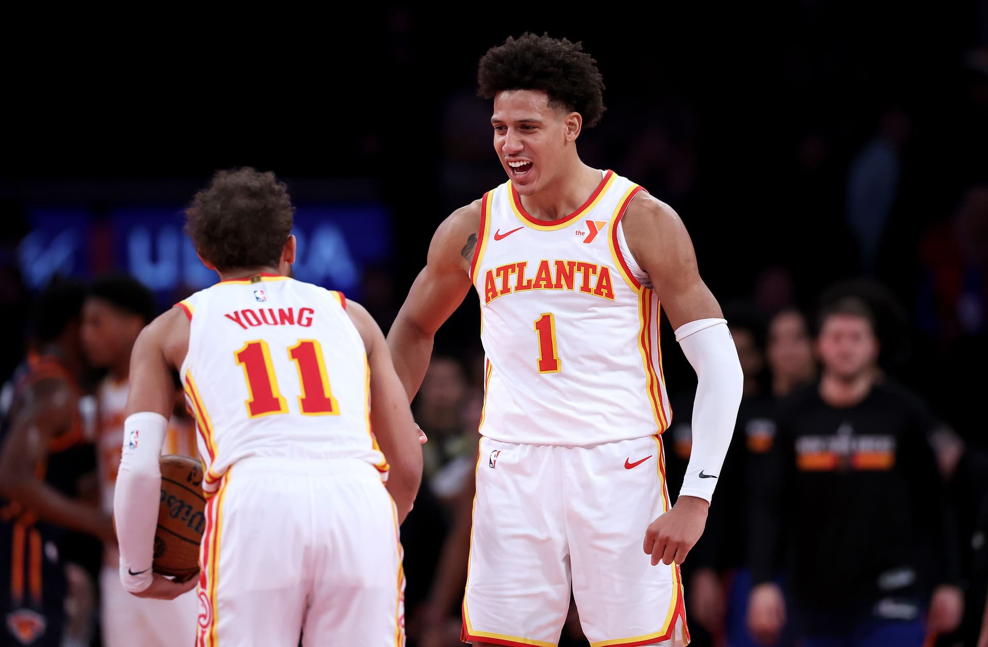 Trae Young of the Atlanta Hawks celebrates the win with teammate Jalen Johnson